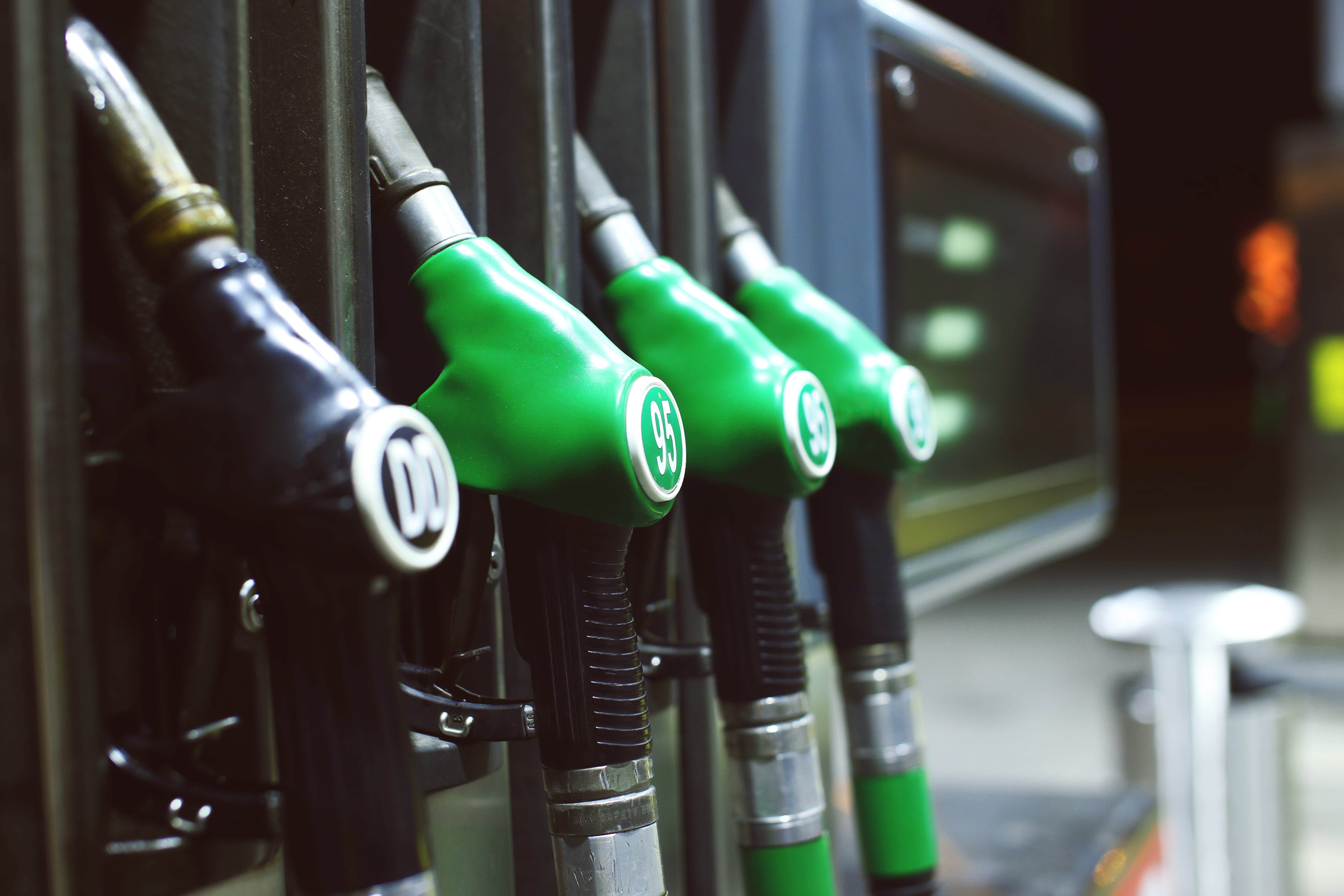 Fuel pump nozzle dispensing petrol, representing rising fuel prices and tips to reduce fuel consumption